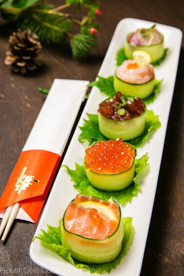 Cucumber Wrapped Sushi on a white long plate.