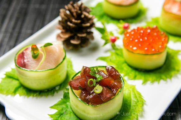 Cucumber Wrapped Sushi on a white plate.