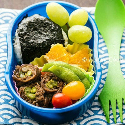 Asparagus Beef Roll Bento with rice ball, edamame and fruit.