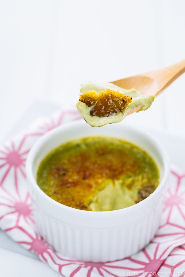 Green tea creme brulee in a white ramekin.