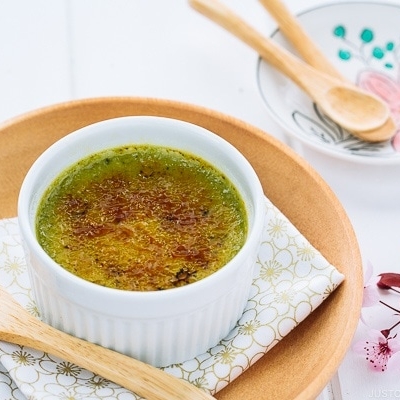 Green tea creme brulee in a white ramekin.