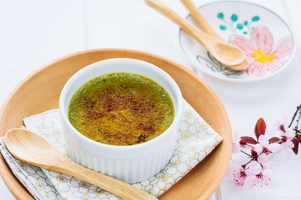 Green tea creme brulee in a white ramekin.