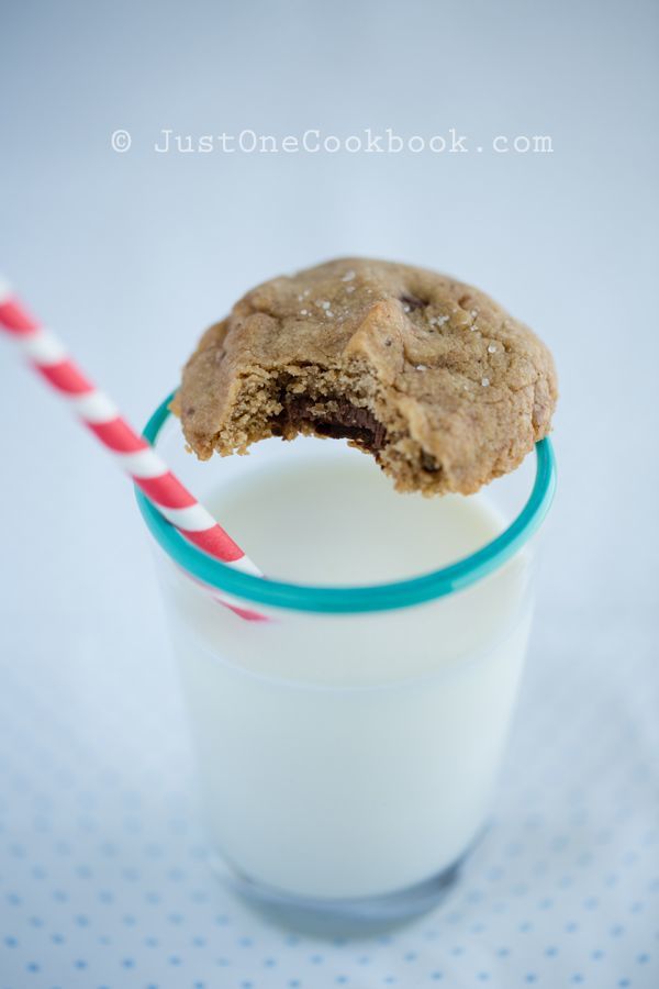 Chocolate Chip Cookies with Nutella and a glass of milk on a table.