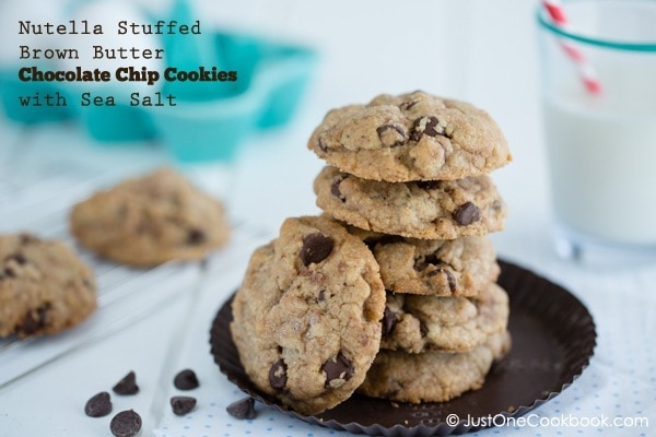 Chocolate Chip Cookies with Nutella on a plate and a glass of milk.