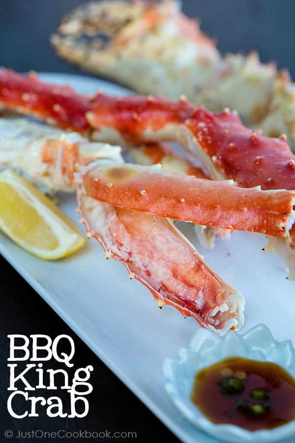 BBQ King Crab Legs with Ponzu Sauce on a plate.