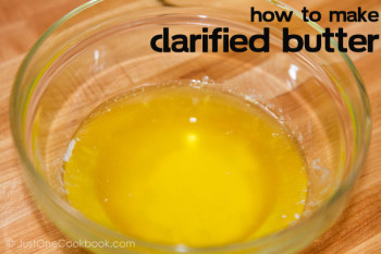 clarified butter inside a glass bowl on top of cutting board