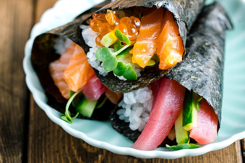 delicious hand roll temaki sushi served on a plate