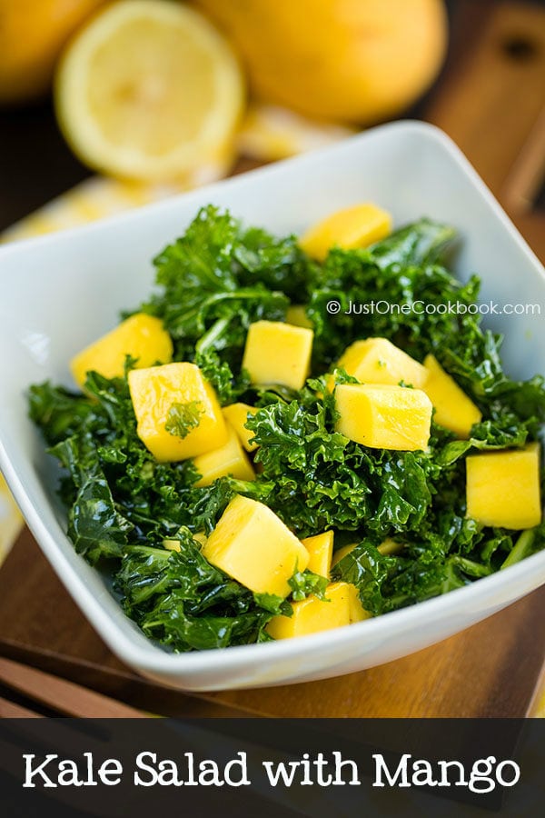 Kale Salad with Mango in a white dish.