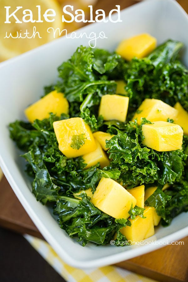 Massaged Kale Salad with Mango in a white dish.