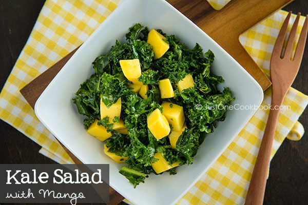 Kale Salad with Mango in a white plate.