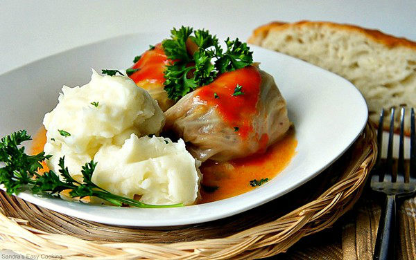 Sour Cabbage Meat Rolls with mush potato on a plate.