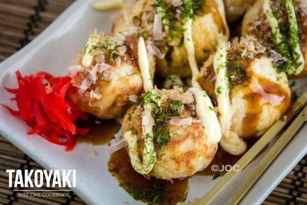 Takoyaki on a white plate.