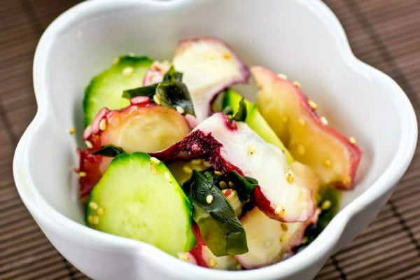 Octopus Salad in a white small bowl.