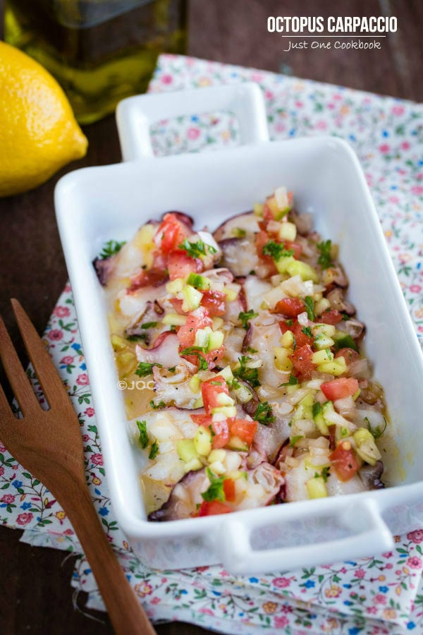 Octopus Carpaccio in a white dish.