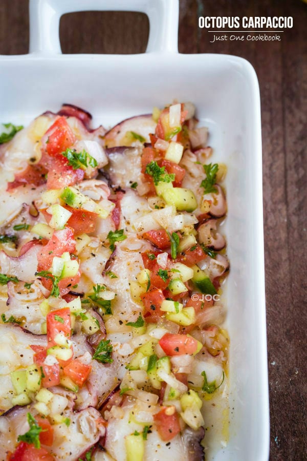 Octopus Carpaccio in a white dish.