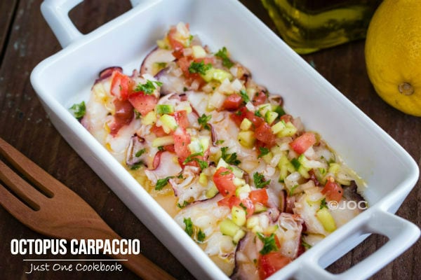 Octopus Carpaccio in a white dish.