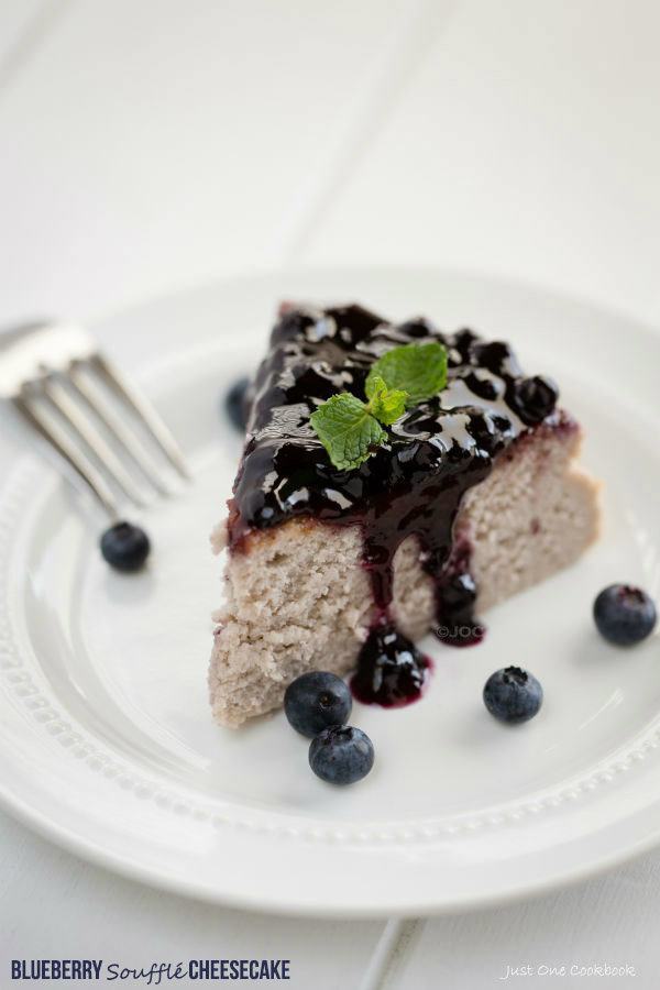 Blueberry Soufflé Cheesecake with blueberries on a white plate.