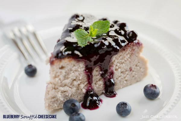 Blueberry Soufflé Cheesecake with blueberry jam on a plate.