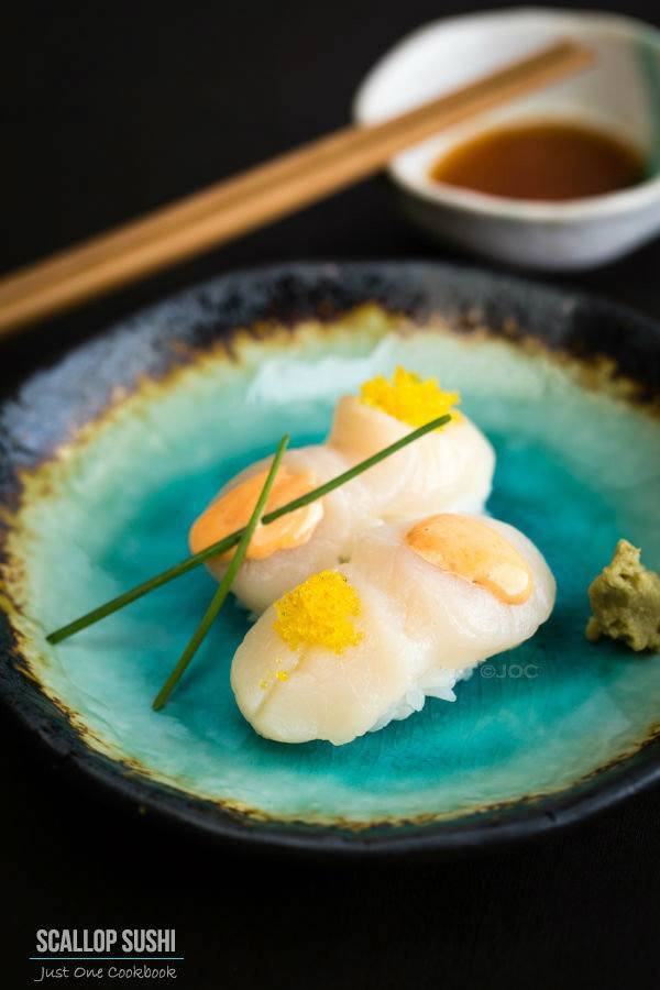 Scallop Sushi with Spicy Mayo and Yuzu Flavor Tobiko on a plate.