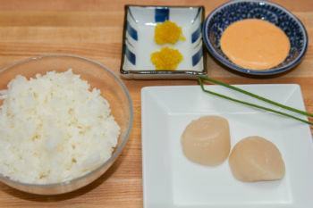 scallops on a white plate, rice in a glass bowl, mayo in a dish on cutting board