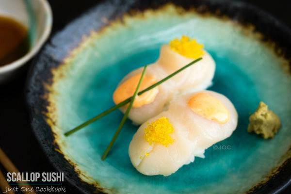 Scallop Sushi with Spicy Mayo and Yuzu Flavor Tobiko on a plate.