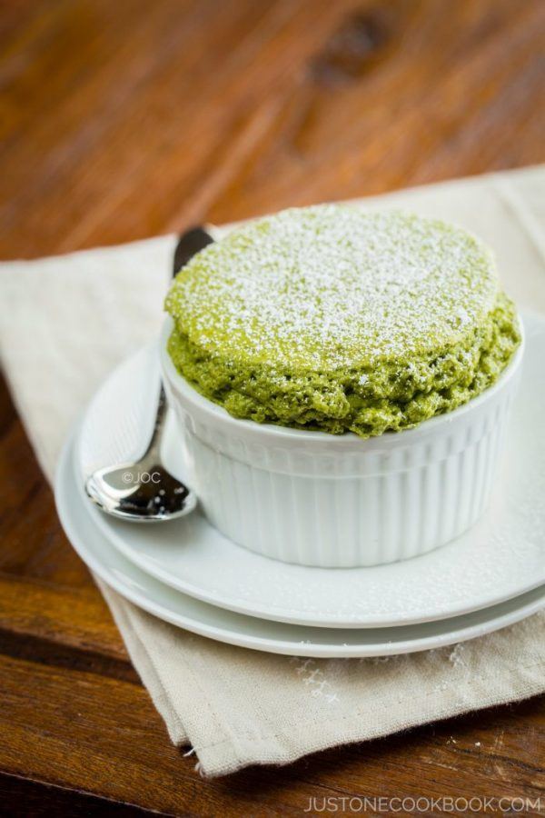Green Tea Souffle in a white cup on wooden table.