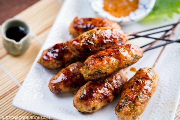 Japanese Chicken Meatballs in sticks on a plate.