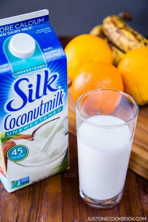 Silk Coconutmilk in a glasses and milk carton on a table.