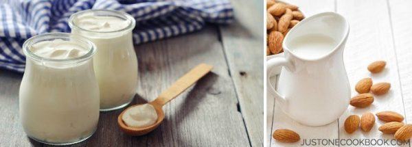 Yogurt and Almond milk on a wooden table.