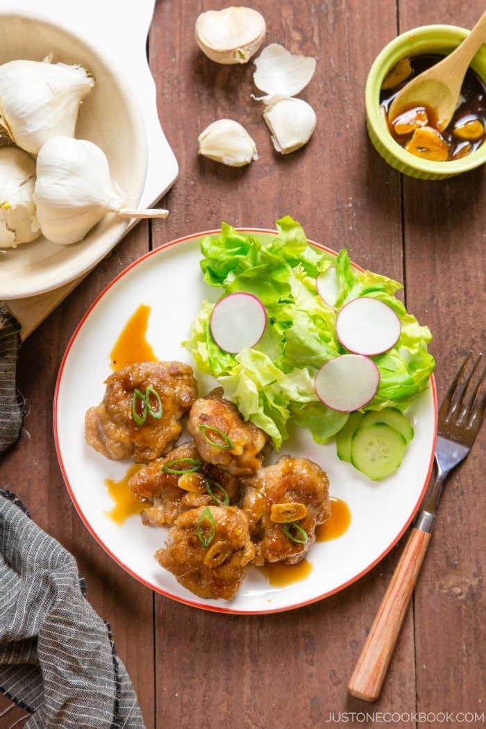 Teriyaki Pork Ball with green salad on a white plate.