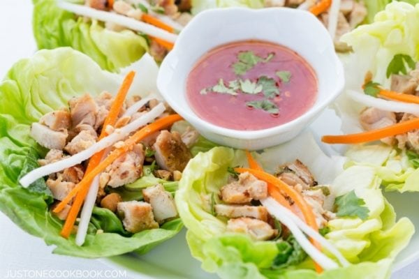 Thai Chicken Lettuce Wraps on a plate with sweet chili sauce.