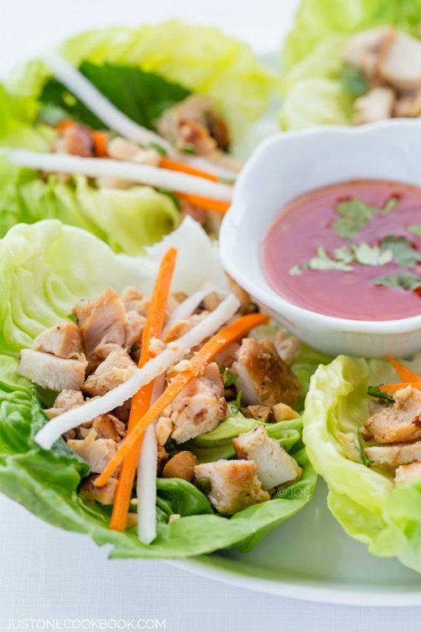 Thai Chicken Lettuce Wraps on a plate with sweet Thai chili sauce.