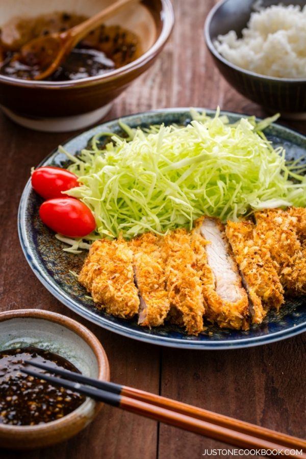 Baked Tonkatsu with cabbage salad on the plate.