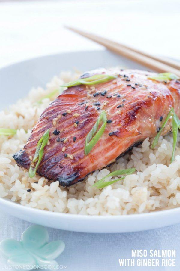 Miso Salmon on top of the rice in a white bowl.