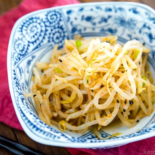 Spicy bean sprout salad served as a side in a bowl