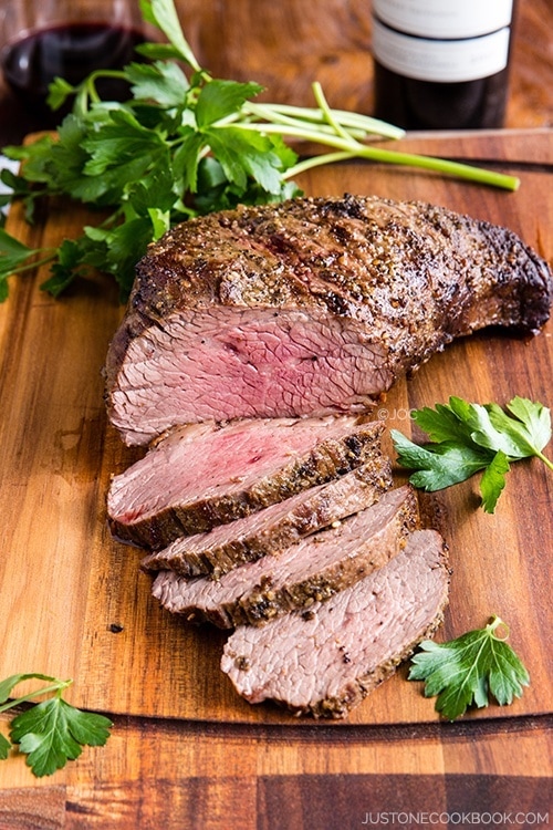 Tender and Juicy Wood-Smoked Tri-Tip on a cutting board.