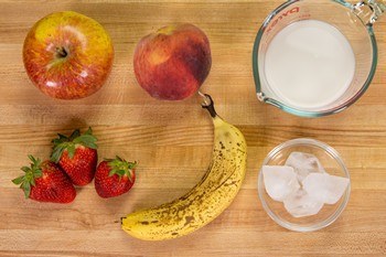 ingredients for Strawberry Banana Smoothie on cutting board