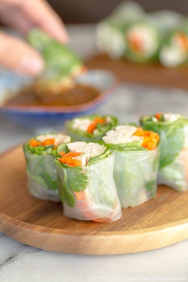 Chicken Spring Rolls on a wooden plate.