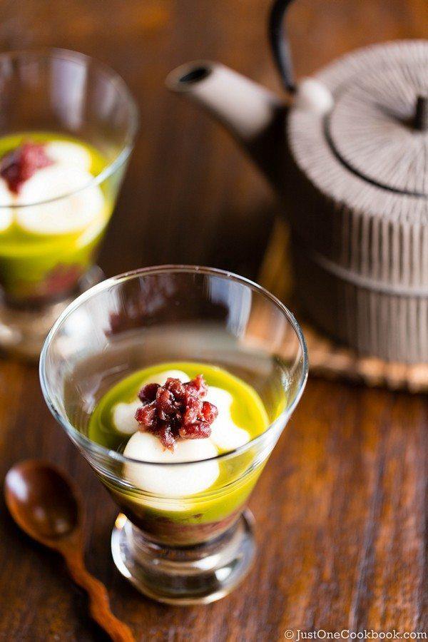 Matcha Zenzai with Anko (Sweet red bean) in the glass on wooden table with Japanese tea pot.