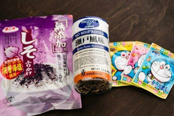 Furikake in packages on a wooden table.