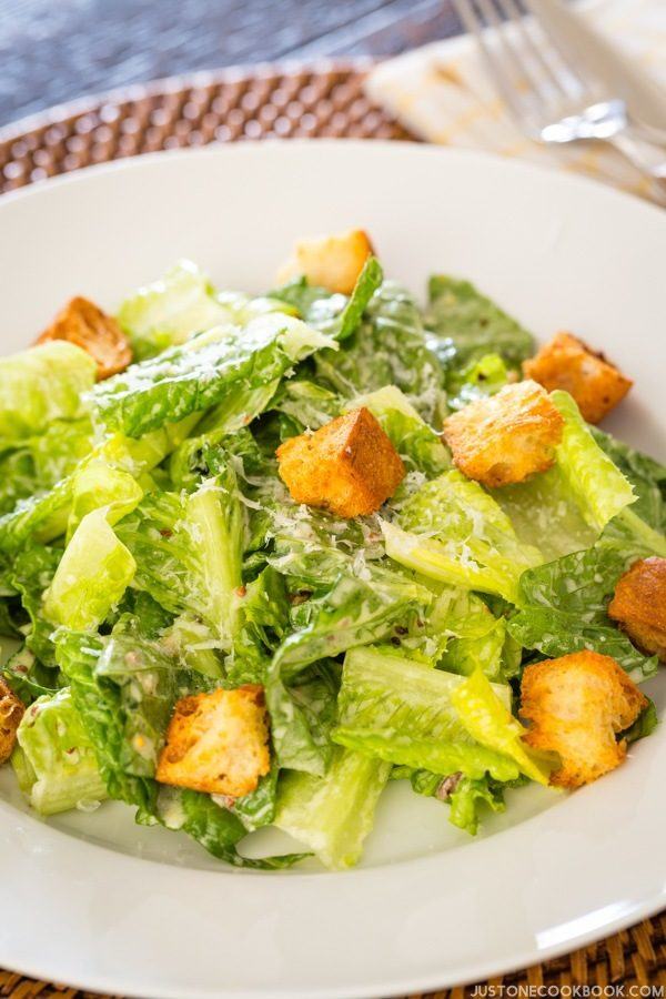Caesar Salad with Homemade Croutons on a white plate.