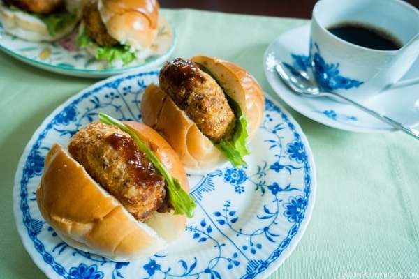 Mom's Korokke Sando on a plate and a cup of coffee.