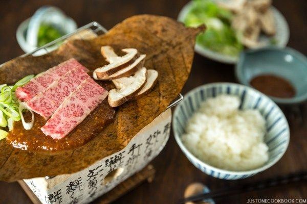 Hoba Miso with Beef on BBQ grill and a bowl of rice.