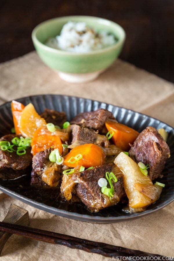 Pressure Cooker Short Ribs in a plate and bowl of rice on the table.