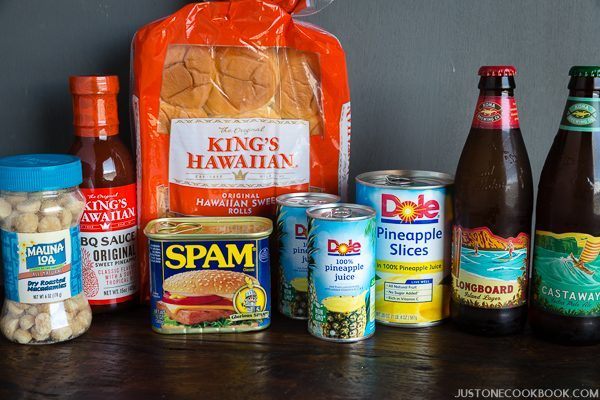 Hawaiian Products, nuts, Hawaiian BBQ sauce, spam, pineapple, sweet rolls and Hawaiian beer on a table.