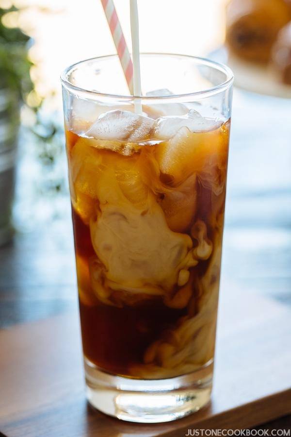 A glass of Cold Brew Coffee with milk on a table.