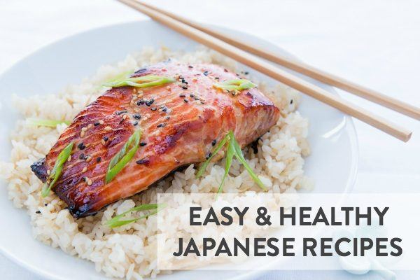 Salmon on top of the rice in a white bowl. 