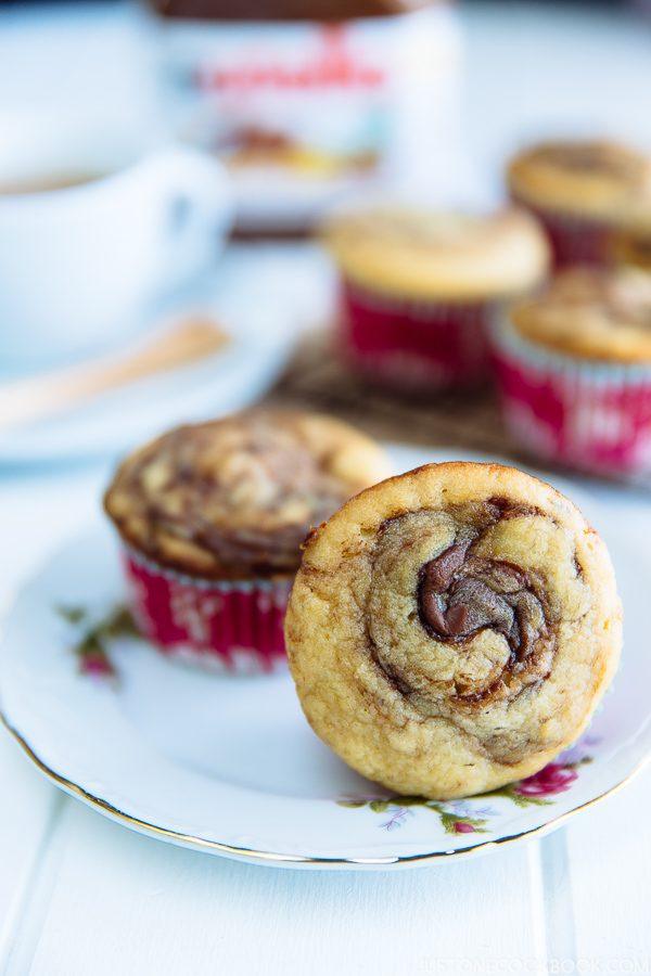 Caramelized Banana Muffins on a plate and cup of tea on a table.