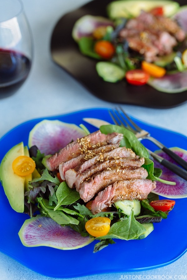 Steak Salad with Shoyu Dressing (gluten free) on a blue plate.