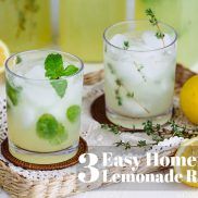 lemonade with ice in clear glass on top of clothes inside a tray